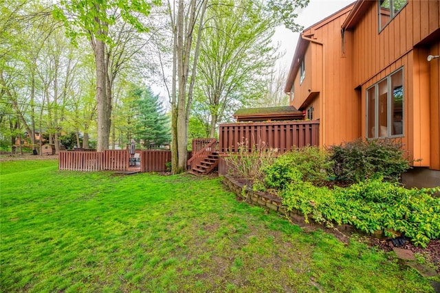 view of grassy yard featuring a wooden deck