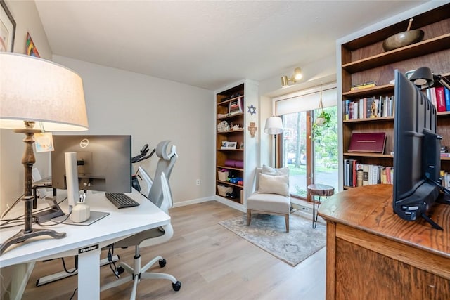 home office with wood finished floors and baseboards
