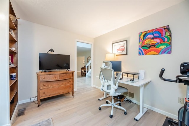 office featuring light wood-type flooring and baseboards