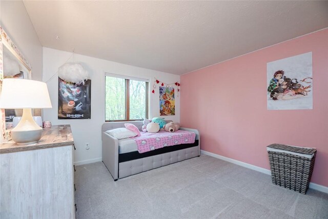 carpeted bedroom featuring baseboards