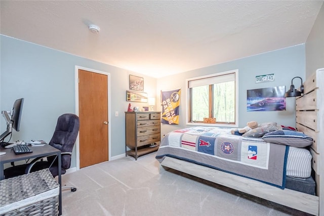 bedroom with carpet flooring and a desk