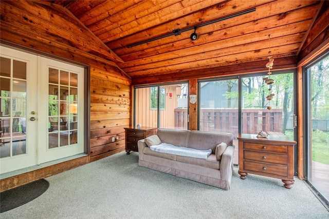 sunroom featuring french doors, wooden ceiling, carpet flooring, and wood walls