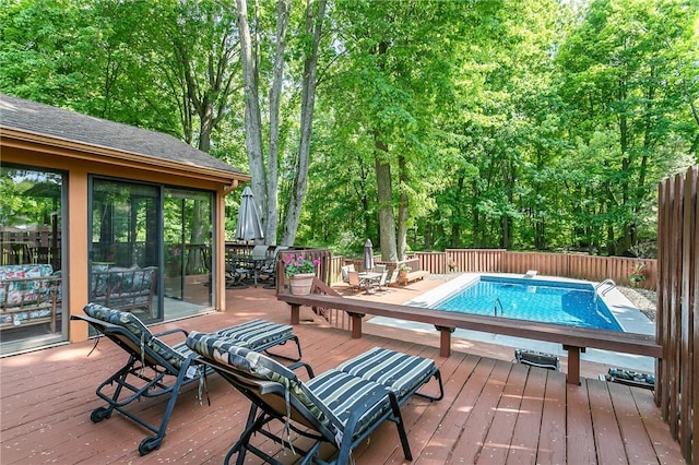 wooden deck with outdoor dining area and fence