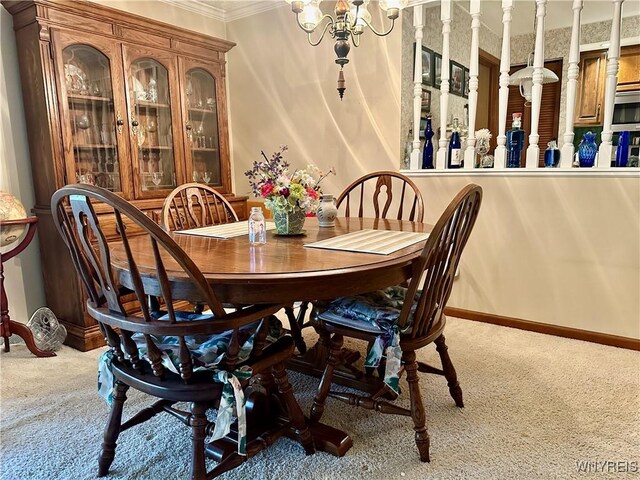carpeted dining area featuring baseboards, crown molding, and a chandelier