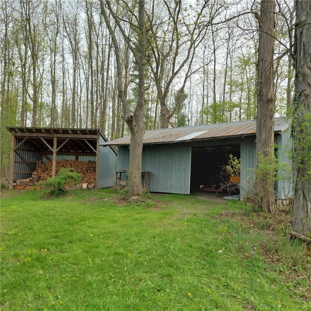 4510 Colvin Hill Rd, Troupsburg, NY 14898 - back of property featuring an outbuilding, a lawn, an outdoor structure, and metal roof