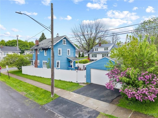 view of front of house with a garage, a residential view, and a gate