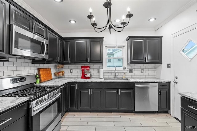 kitchen featuring stainless steel appliances, a sink, dark cabinets, and crown molding
