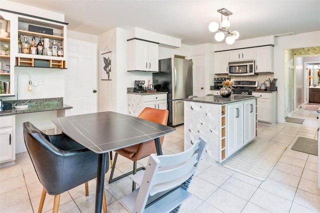 kitchen with stainless steel appliances, open shelves, and white cabinets