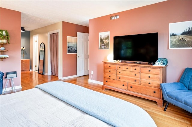 bedroom with wood finished floors and baseboards