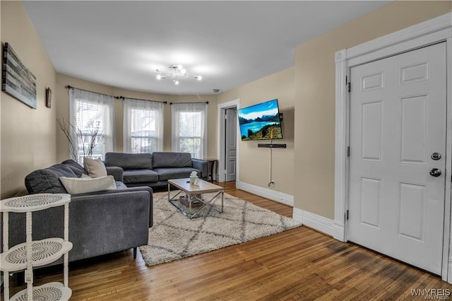 living area featuring baseboards and wood finished floors