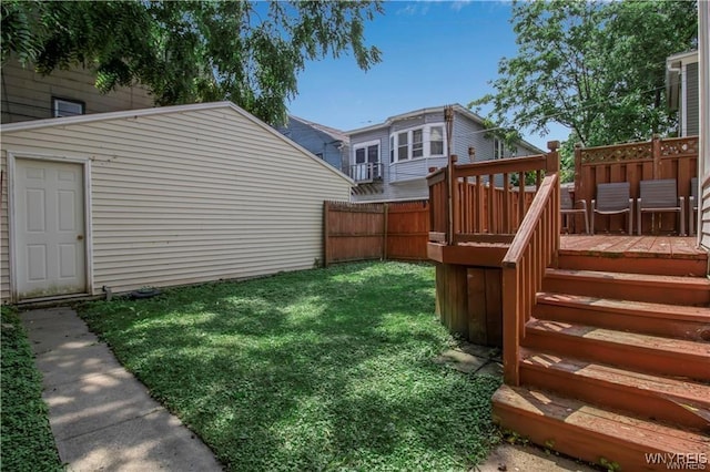 view of yard featuring a wooden deck and an outbuilding