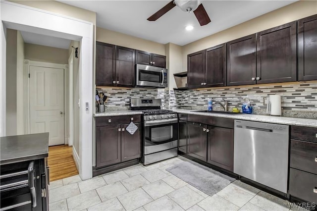 kitchen with appliances with stainless steel finishes, a sink, ceiling fan, dark brown cabinetry, and recessed lighting