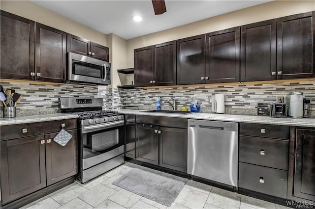 kitchen with stainless steel appliances, a sink, decorative backsplash, and recessed lighting