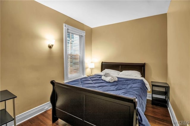 bedroom featuring baseboards and wood finished floors