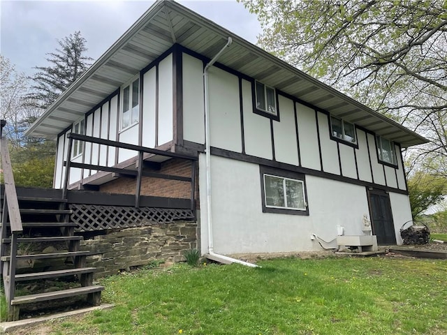 120 Bradley Ct, Horseheads, NY 14845 - view of side of home featuring stucco siding, board and batten siding, and a yard