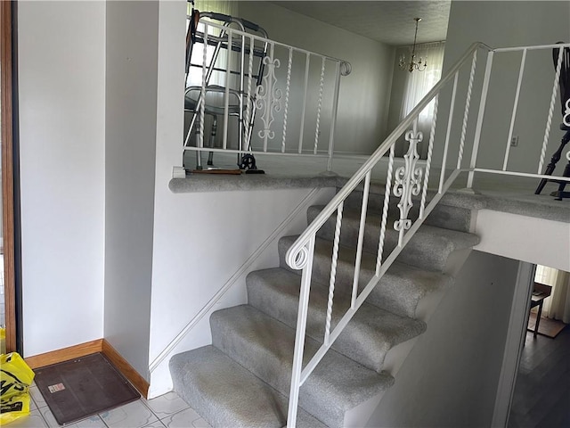 120 Bradley Ct, Horseheads, NY 14845 - staircase featuring baseboards and a chandelier