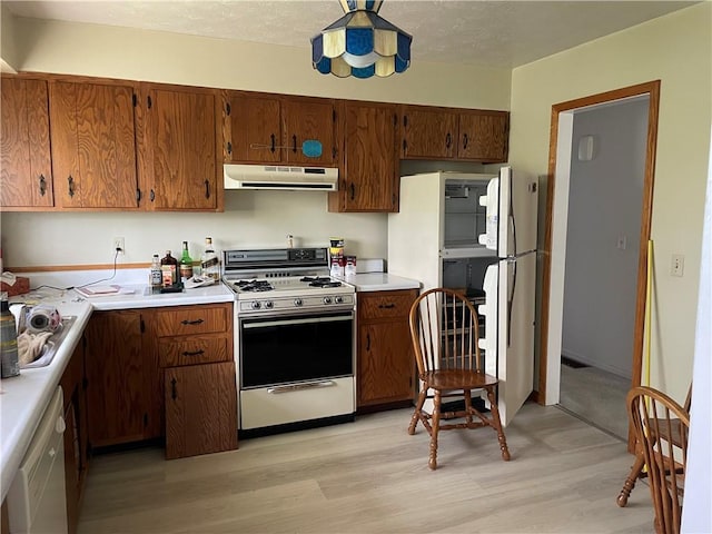 120 Bradley Ct, Horseheads, NY 14845 - kitchen featuring white appliances, under cabinet range hood, light wood-style flooring, light countertops, and brown cabinets
