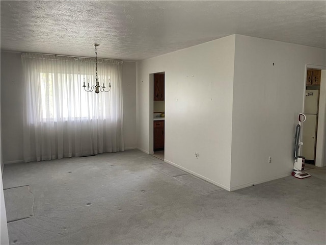 120 Bradley Ct, Horseheads, NY 14845 - spare room featuring light colored carpet, a textured ceiling, a chandelier, and baseboards