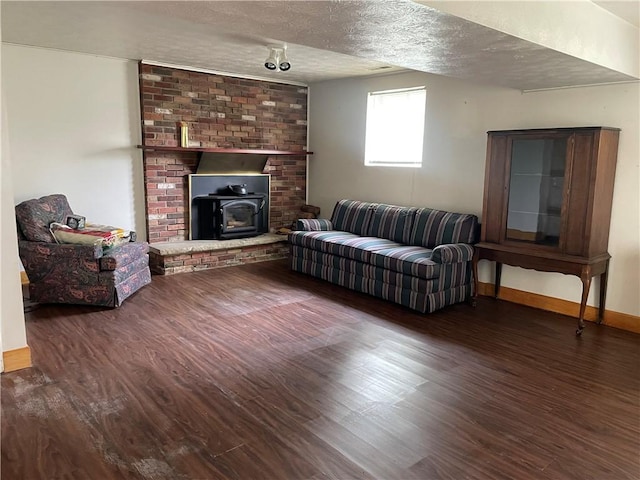 120 Bradley Ct, Horseheads, NY 14845 - living area with wood finished floors, a wood stove, a textured ceiling, and baseboards