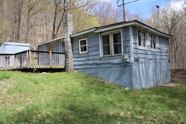 489 Ten Eyck Rd, Decatur, NY 12043 - view of property exterior featuring a deck, a lawn, and a chimney
