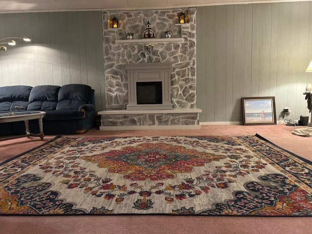 carpeted living room with a fireplace and wood walls