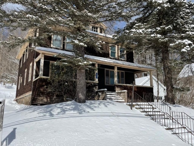 traditional style home with covered porch and stairway