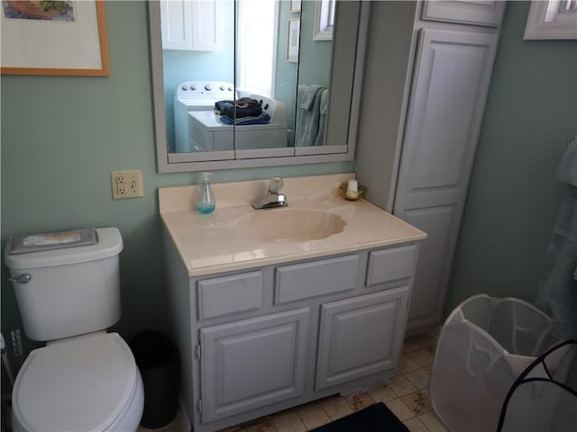 bathroom with vanity, toilet, and washer / clothes dryer