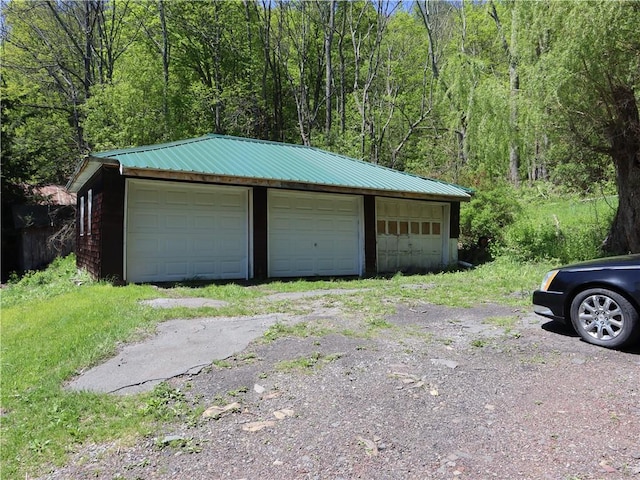 detached garage featuring a forest view