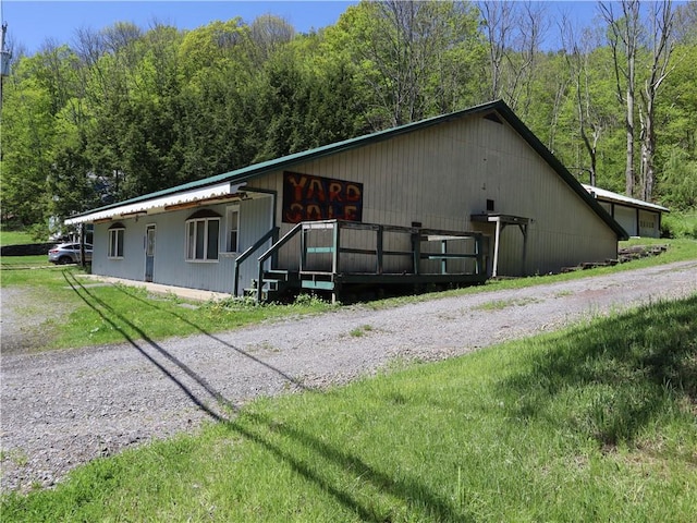 view of side of property featuring a forest view