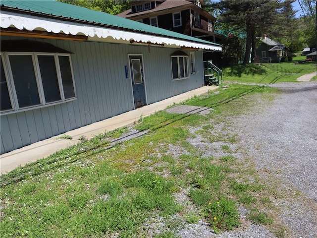 view of side of property with metal roof