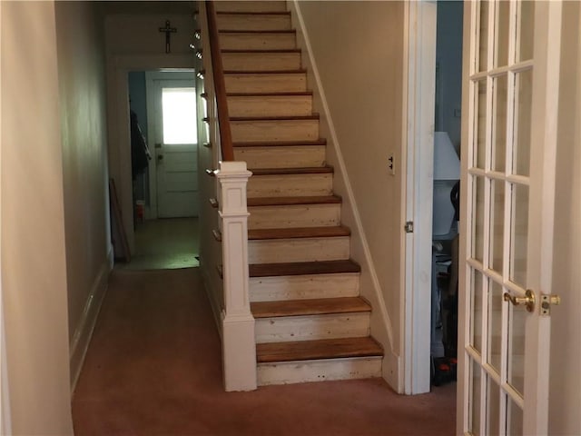 stairs with baseboards and carpet flooring