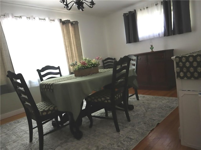 dining space featuring a chandelier and wood finished floors