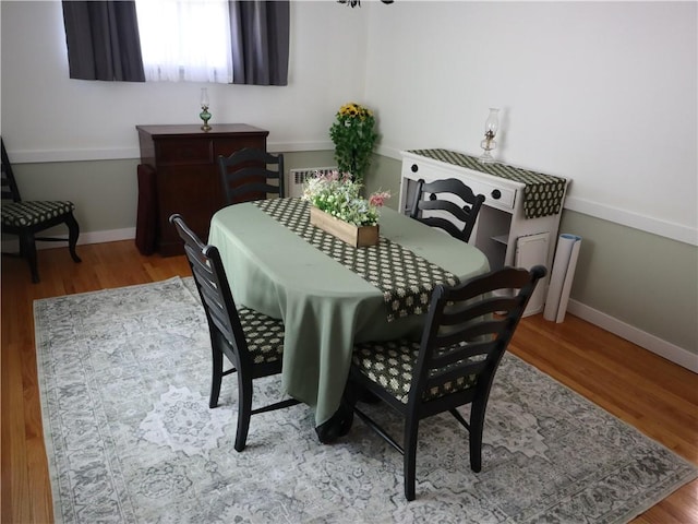 dining room featuring baseboards and wood finished floors