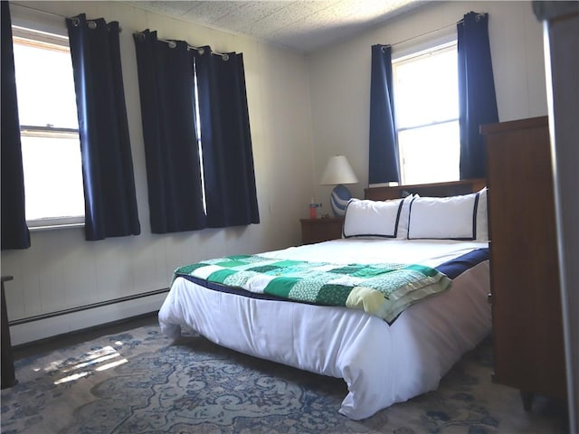 bedroom with a baseboard heating unit