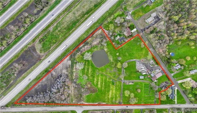 aerial view of property's location featuring a main thoroughfare and property boundaries highlighted