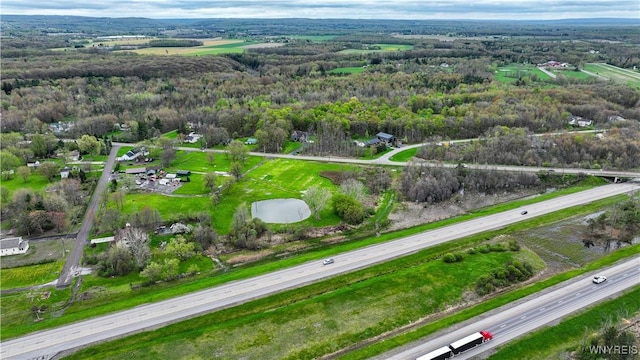 aerial overview of property's location featuring a heavily wooded area and a highway