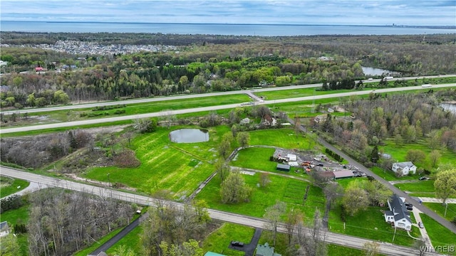 bird's eye view of a nearby body of water and a heavily wooded area
