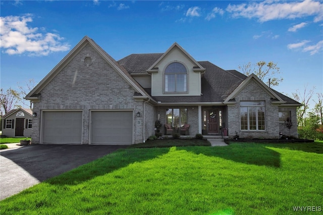 view of front of home featuring asphalt driveway, a porch, a front yard, brick siding, and an attached garage