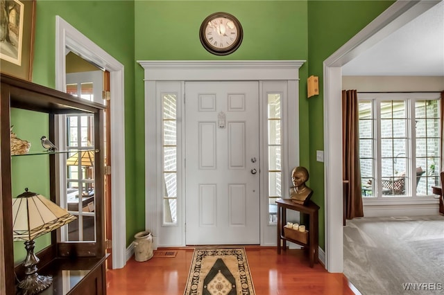 entrance foyer with wood finished floors and baseboards