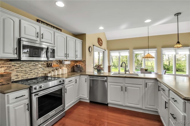 kitchen with appliances with stainless steel finishes, a sink, plenty of natural light, backsplash, and recessed lighting