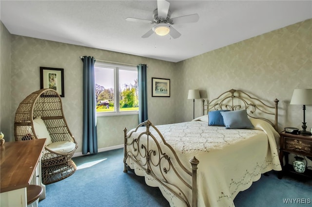 bedroom featuring dark colored carpet, baseboards, and ceiling fan