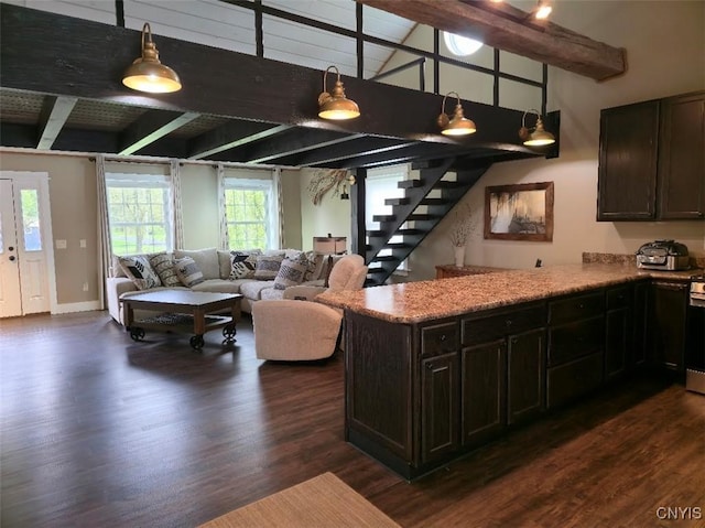 1003 Waterview Dr, Vienna, NY 13308 - kitchen featuring dark wood finished floors, beamed ceiling, open floor plan, a peninsula, and dark brown cabinets