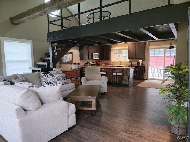 1003 Waterview Dr, Vienna, NY 13308 - living area with beam ceiling, dark wood-style flooring, and a towering ceiling