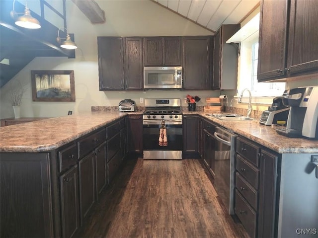 1003 Waterview Dr, Vienna, NY 13308 - kitchen featuring appliances with stainless steel finishes, lofted ceiling, dark wood-style floors, a sink, and a peninsula
