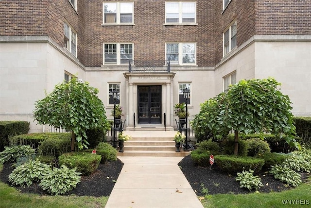 property entrance featuring brick siding