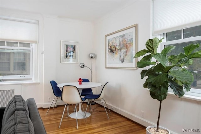 dining space with wood finished floors and baseboards