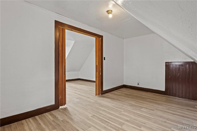 75 Box Ave, Buffalo, NY 14211 - additional living space featuring vaulted ceiling, baseboards, and light wood-style floors