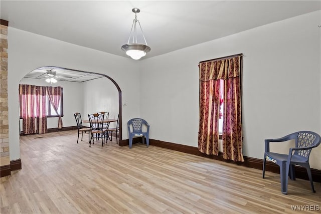 75 Box Ave, Buffalo, NY 14211 - living area with light wood-type flooring, arched walkways, baseboards, and a ceiling fan