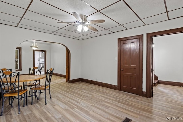 75 Box Ave, Buffalo, NY 14211 - dining area featuring arched walkways, light wood finished floors, a drop ceiling, ceiling fan, and baseboards