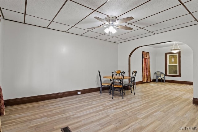 75 Box Ave, Buffalo, NY 14211 - dining room featuring arched walkways, ceiling fan, baseboards, and light wood-style flooring